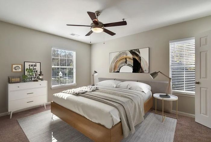 Furnished bedroom with bed and sidetables