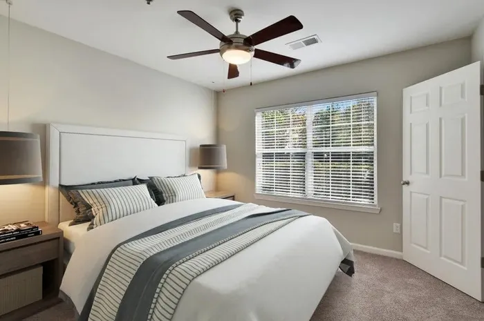 Furnished bedroom with bed and sidetables