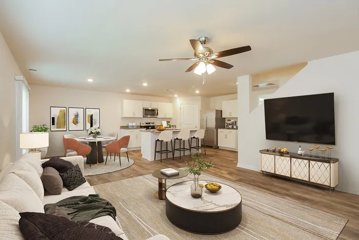 Single Family Homes for Rent Near The Biltmore in Fairview, NC - Fairview Meadows - Living Room Featuring Wood-Style Flooring, Ceiling Fan, Flatscreen TV, Coffee Table, Rug, and Couch