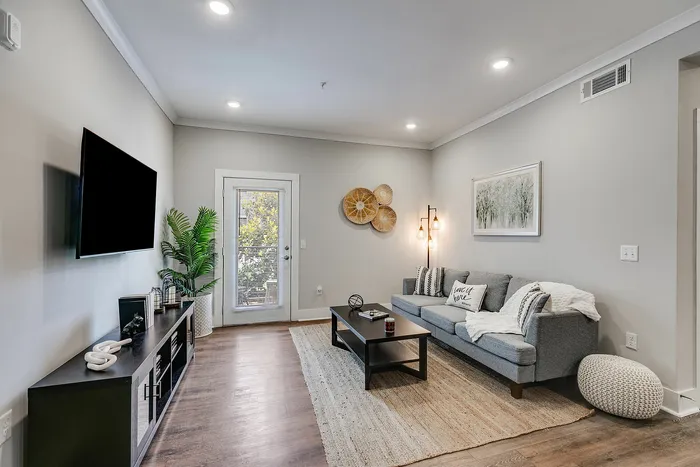Living room with private balcony at Paragon Luxury Apartments in Athens, GA