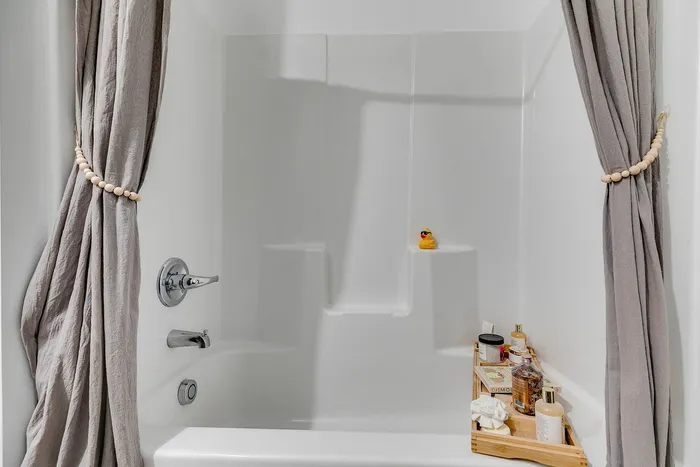 Guest bathroom with shower/tub combo at Paragon Luxury Apartments in Athens, GA