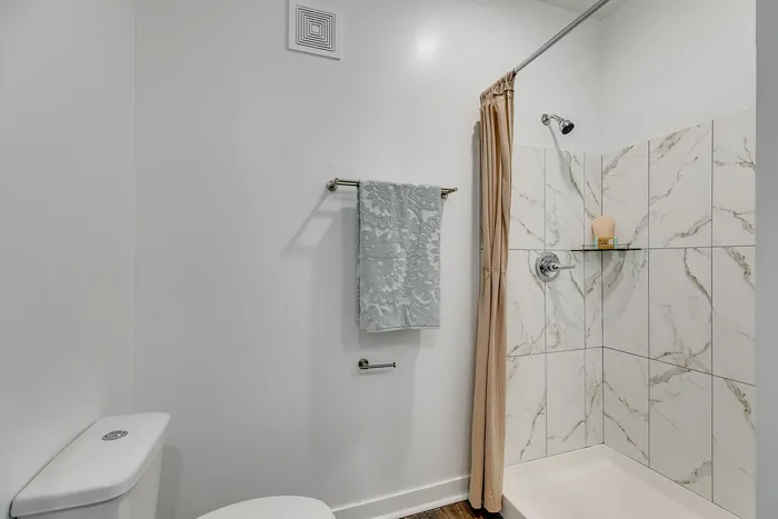 Primary bathroom with walk-in shower at Paragon Luxury Apartments in Athens, GA
