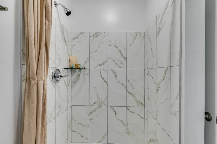 Primary bathroom with walk-in shower at Paragon Luxury Apartments in Athens, GA