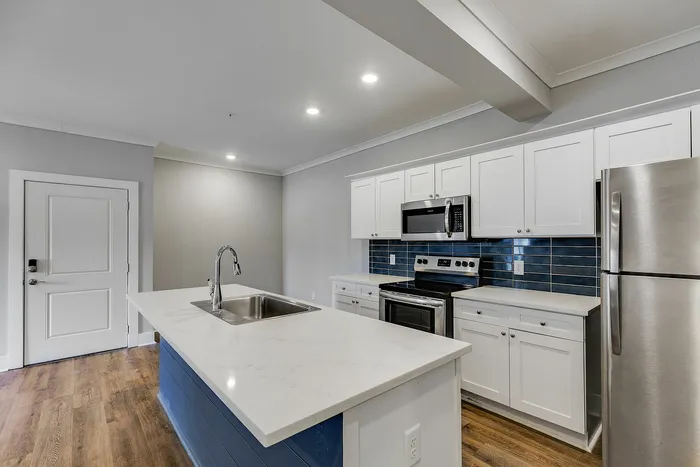 Chef-Inspired kitchen with blue and white cabinets at Paragon Luxury Apartments in Athens, GA
