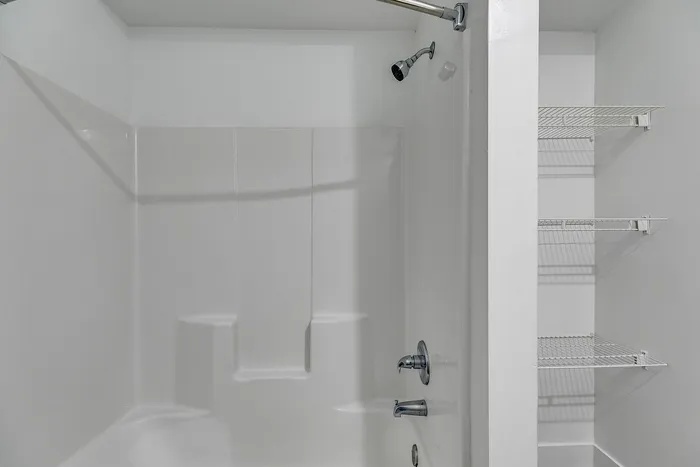 Guest bathroom with shower/tub combo at Paragon Luxury Apartments in Athens, GA