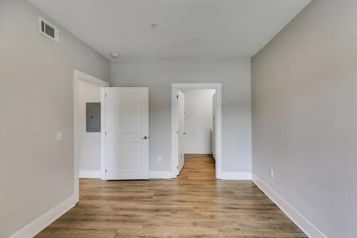 Primary bedroom with vinyl plank flooring at Paragon Luxury Apartments in Athens, GA