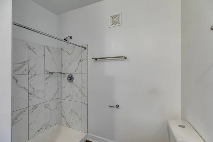 Primary bathroom with walk-in shower at Paragon Luxury Apartments in Athens, GA