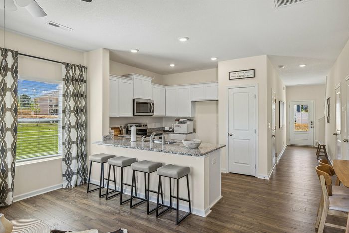 Townhome kitchen with white cabinets