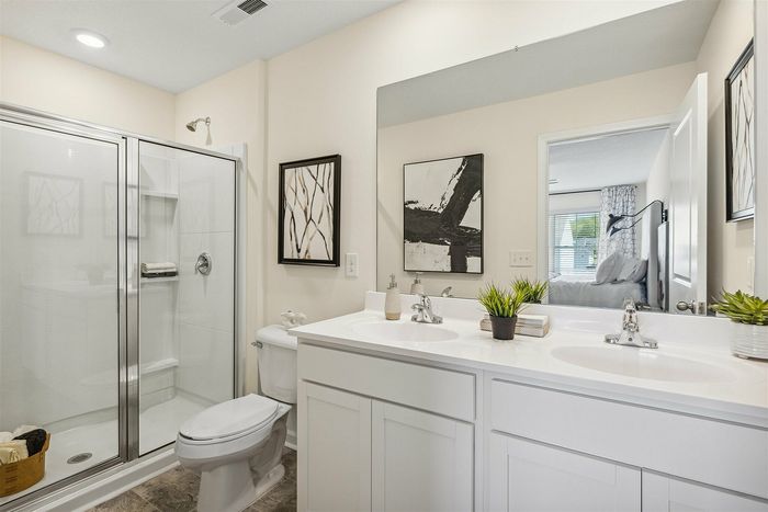 Primary bathroom with walk-in shower and double vanity