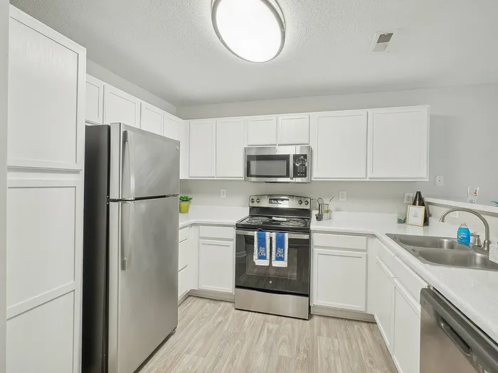 Kitchen with white cabinets and stainless steel appliances