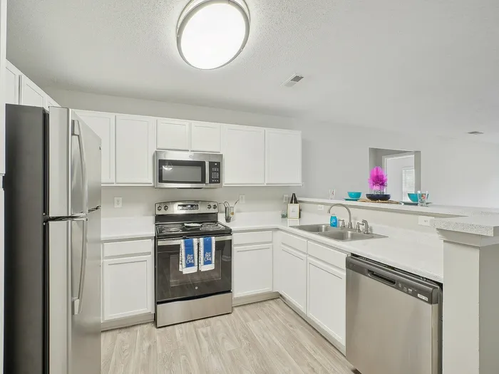 Kitchen with white cabinets and stainless steel appliances