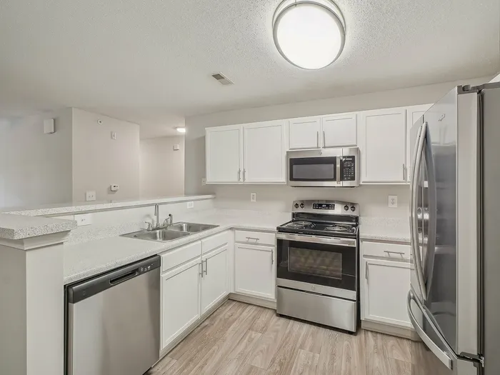 Kitchen with white cabinets and stainless steel appliances