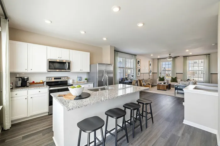 Kitchen with white cabinets and large island at The Meadows at Berkeley Ridge in Martinsburg, WV