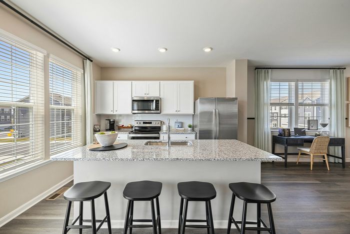 Kitchen with white cabinets and large island at The Meadows at Berkeley Ridge in Martinsburg, WV