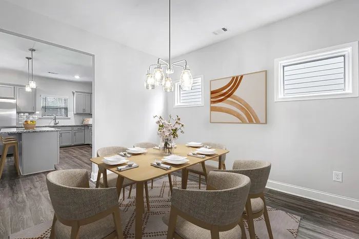 Virtually staged dining room with table and chairs
