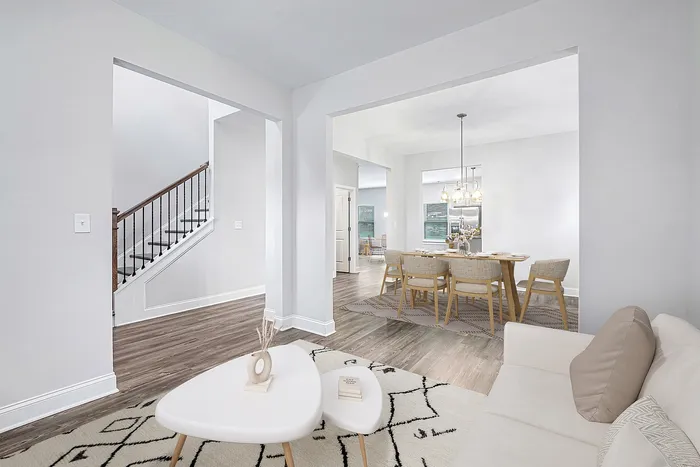 Virtually staged Living room with couch and coffee table and dining room with table and chairs