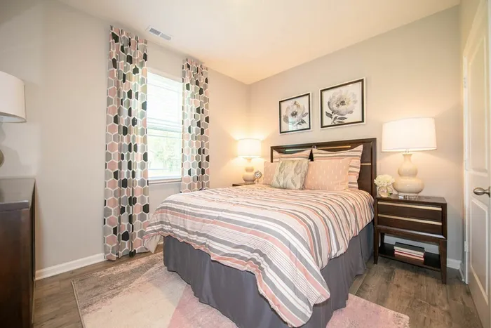 Bedroom with bed, dresser and bedside tables