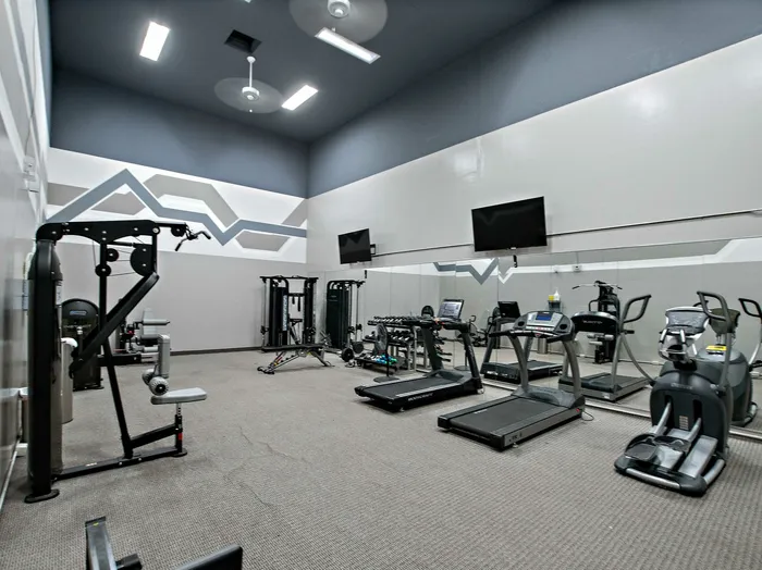fitness center with cardio machines and free weights