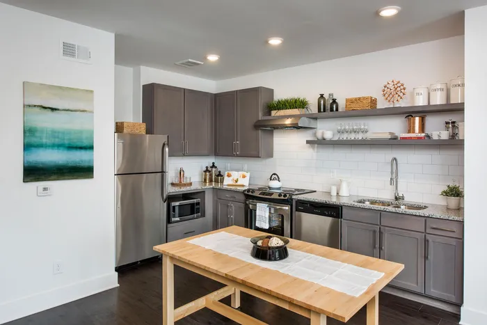 Kitchen interior with stainless steel appliances and wood style flooring