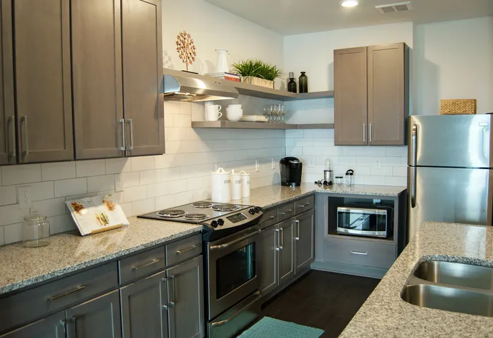 Kitchen interior with stainless steel appliances and wood style flooring
