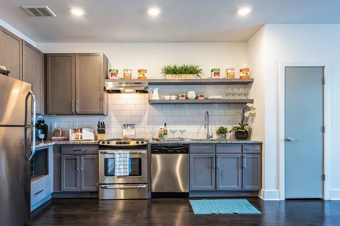 Kitchen interior with stainless steel appliances and open shelving