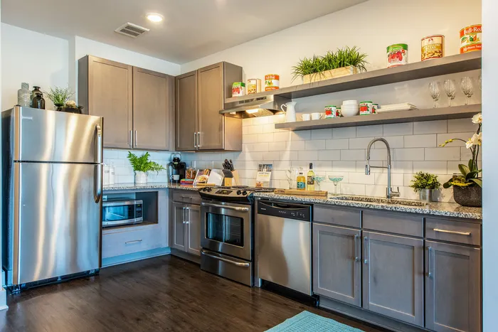 Kitchen interior with stainless steel appliances and open shelving
