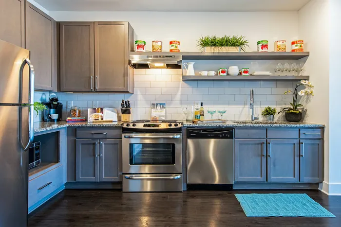 Kitchen interior with stainless steel appliances and open shelving