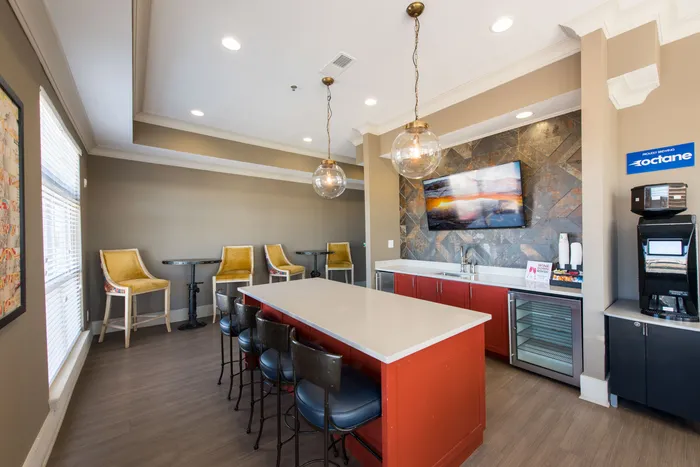 clubroom with entertaining bar top, tv, and coffee station