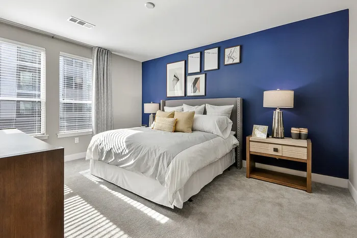 Bedroom with queen bed and carpet