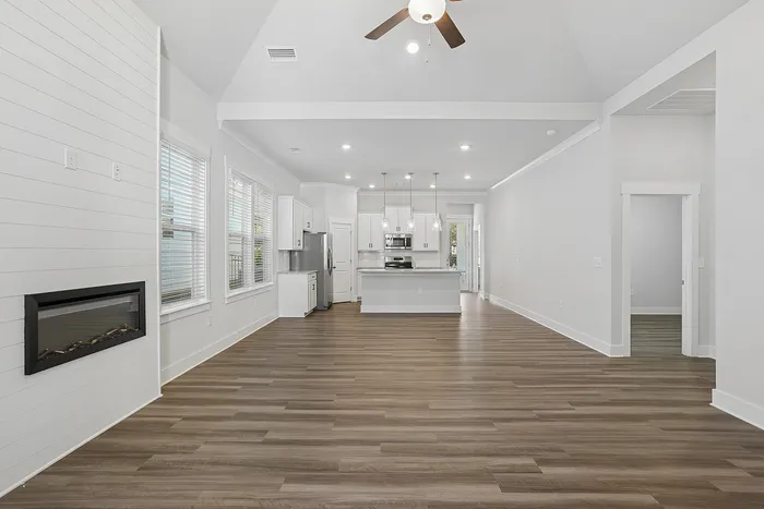 large open living space with fireplace and vinyl plank flooring