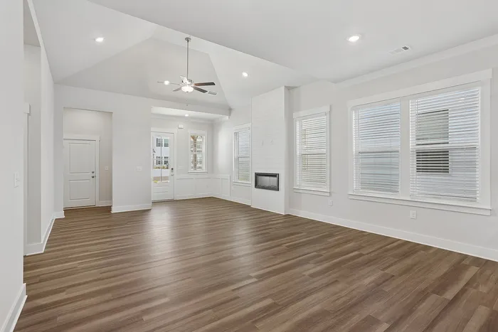 large open living space with fireplace and vinyl plank flooring