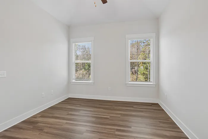 luxury vinyl blank flooring in bedroom with ceiling fan