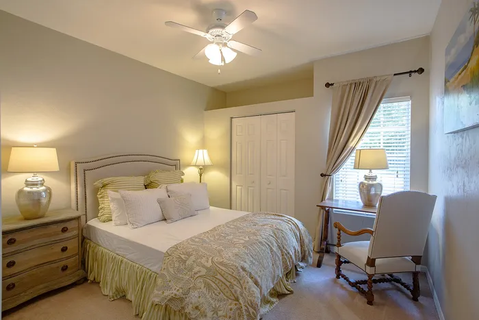 Bedroom with large bed and desk