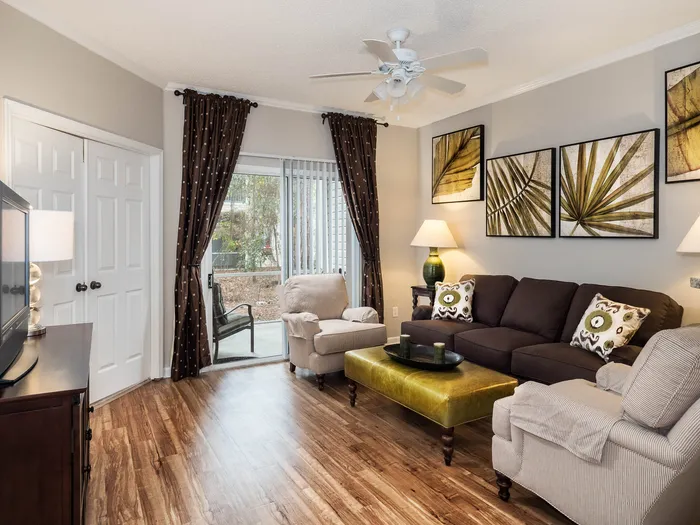 decorated living room with wood style flooring and sliding glass patio door
