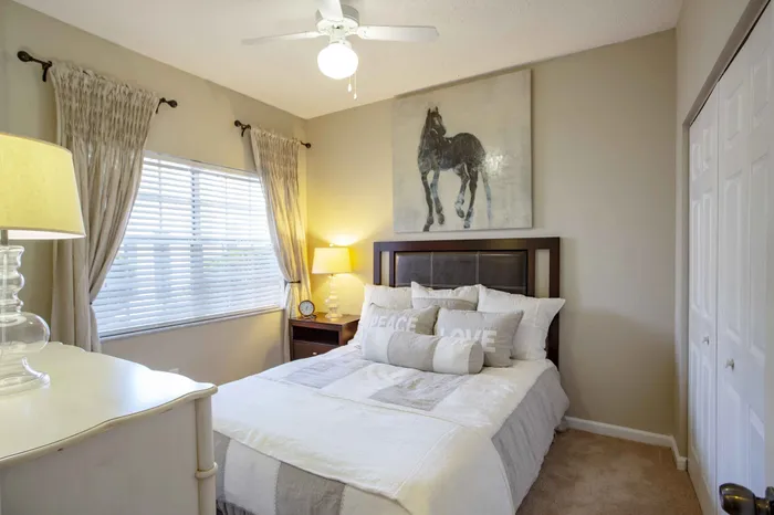 furnished guest bedroom with carpet