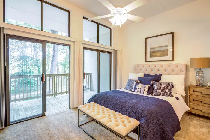 Spacious bedroom with high ceilings and windows