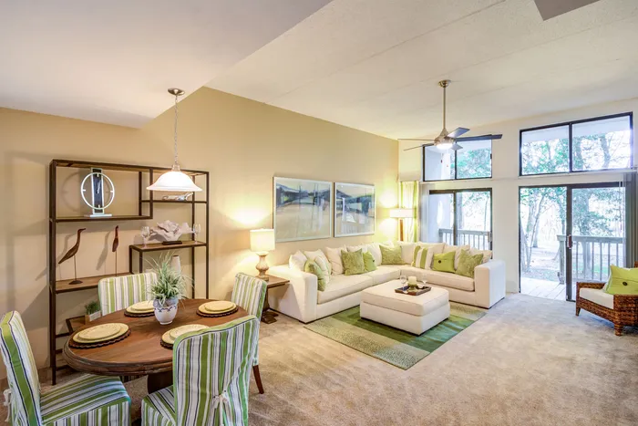 decorated living room with high ceilings and windows