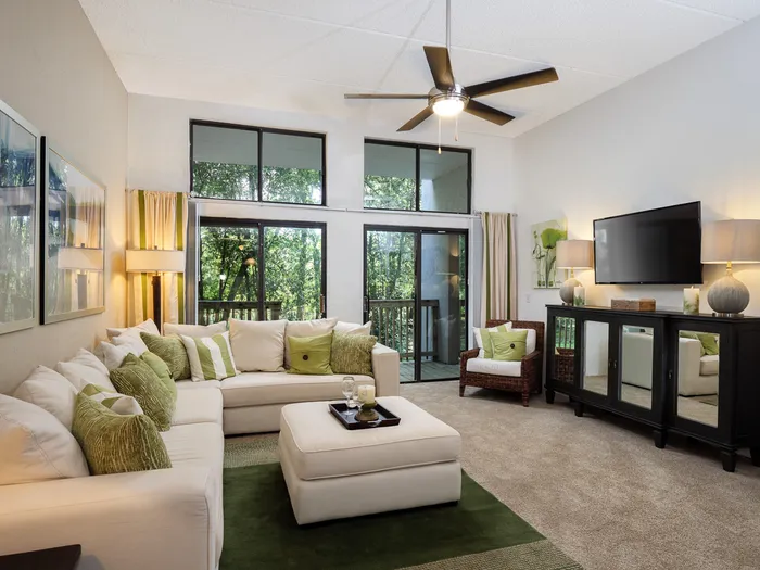 furnished living room with floor to ceiling windows