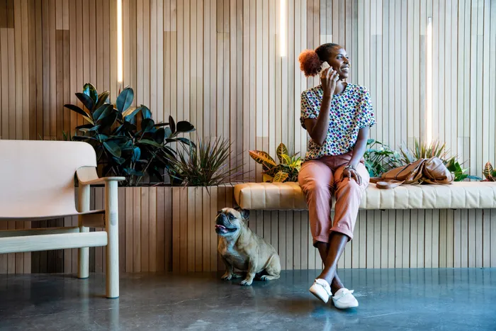 woman with dog sitting in lobby