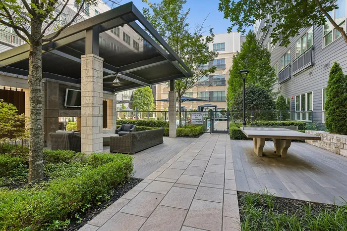 outdoor lounge area with tv and ping pong