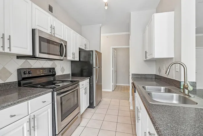 kitchen with stainless steel appliances and white cabinets