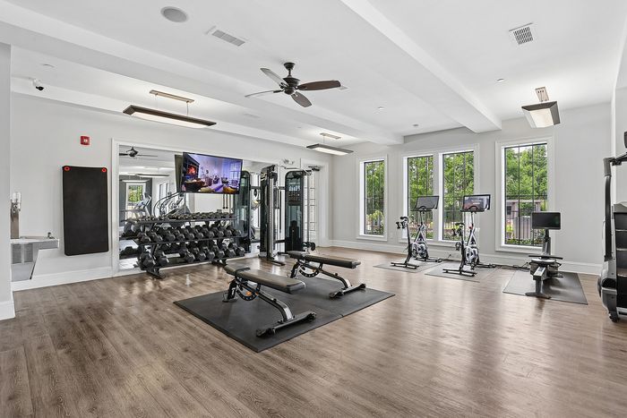 fitness center with equipment and large windows