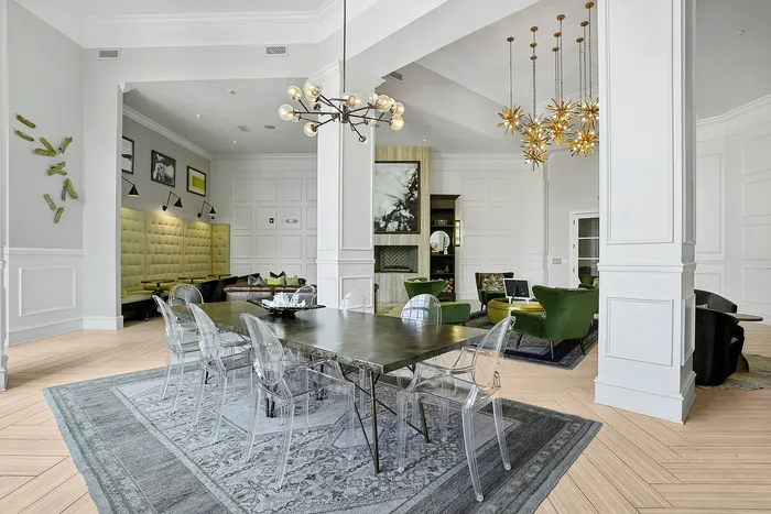 clubroom with tall ceilings, chandelier, and dining table
