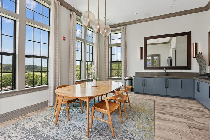 sky lounge with tall ceilings and dining table with a mirror