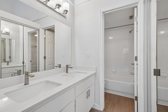 Modern bathroom with dual sinks, sleek fixtures, and elegant lighting, creating a luxurious and refreshing space.