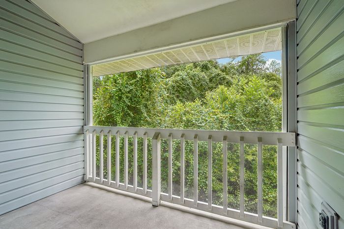 Charming balcony with lush green views, perfect for relaxing and enjoying nature.