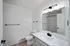 Sleek bathroom interior with modern white fixtures and stylish black accents.