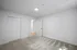 Sleek, bedroom with sliding closet doors and soft carpeting.