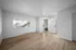Open and airy living room with tons of storage and large window for natural light.
