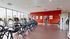 Modern fitness center with panoramic windows featuring state-of-the-art cardio and strength training equipment
